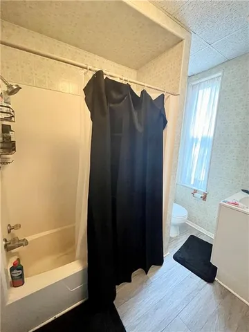 a bathroom with a bathtub and a shower