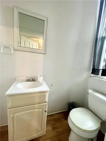 a bathroom with a toilet sink and mirror