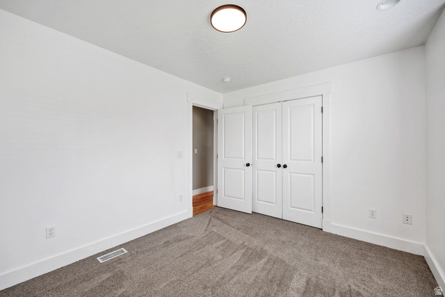 2912 South 1080th Street West Logan, UT 84321 - Photo 8 of 43 Neutral white walls complemented by a neutral-toned carpet