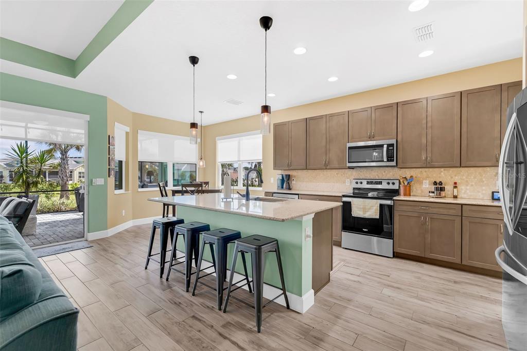 422 Good Life Way Daytona Beach, FL 32124 - Photo 13 of 79 a large kitchen with cabinets table and chairs
