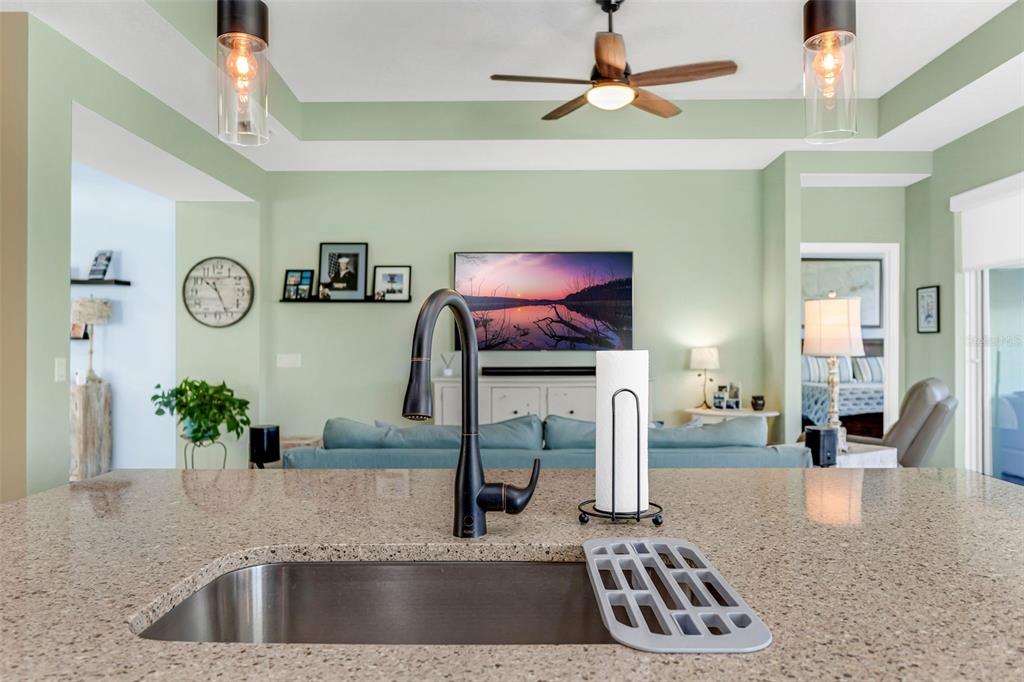 422 Good Life Way Daytona Beach, FL 32124 - Photo 17 of 79 a kitchen with a faucet a stove and a flat screen tv