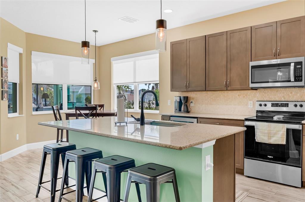 422 Good Life Way Daytona Beach, FL 32124 - Photo 18 of 79 a kitchen with a stove a sink and a wooden cabinets