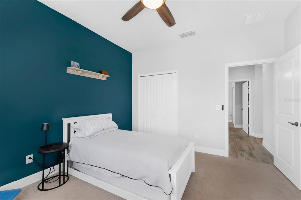 422 Good Life Way Daytona Beach, FL 32124 - Photo 35 of 79 a bedroom with a bed and a chandelier