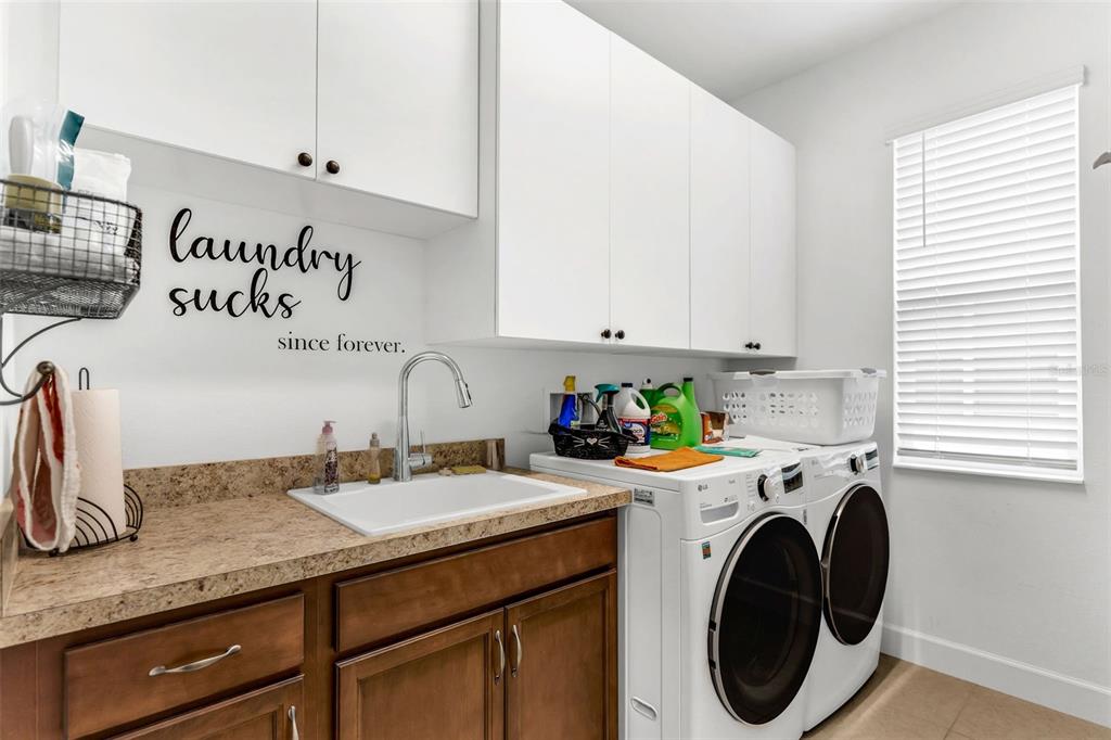 422 Good Life Way Daytona Beach, FL 32124 - Photo 39 of 79 a utility room with sink dryer and washer