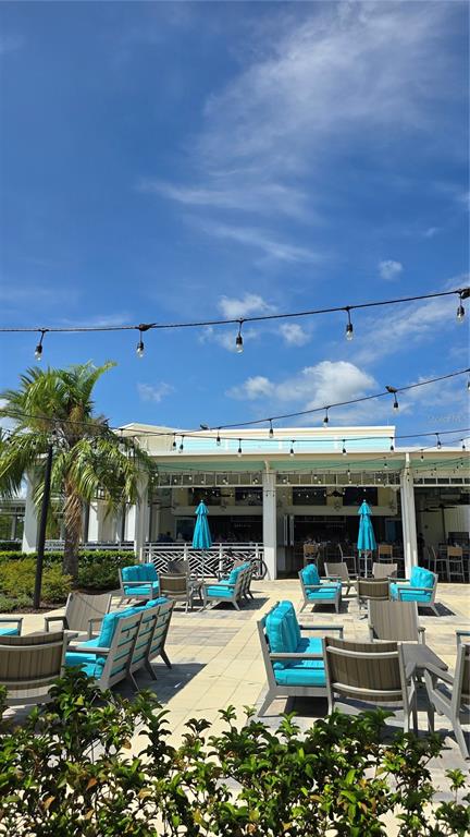 422 Good Life Way Daytona Beach, FL 32124 - Photo 64 of 79 a view of a chairs and tables in the patio in front of a building