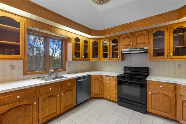 a kitchen with stainless steel appliances granite countertop a sink stove and cabinets