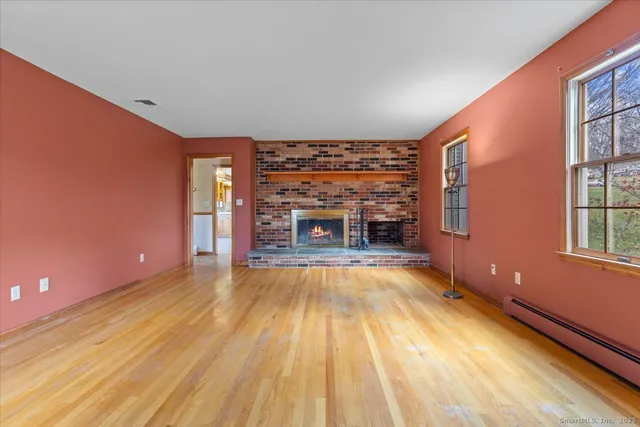 a view of empty room with a fireplace