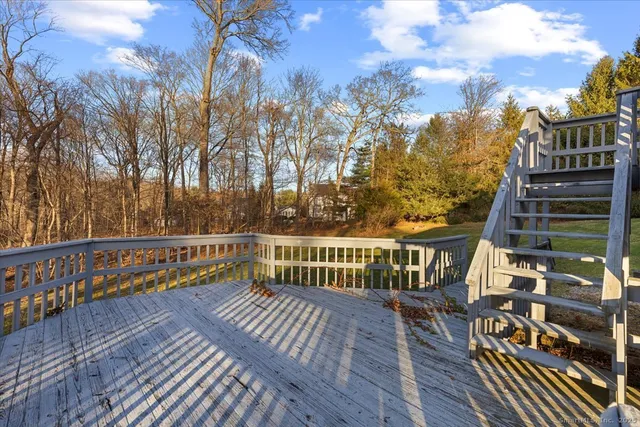 a view of balcony with wooden floor and fence