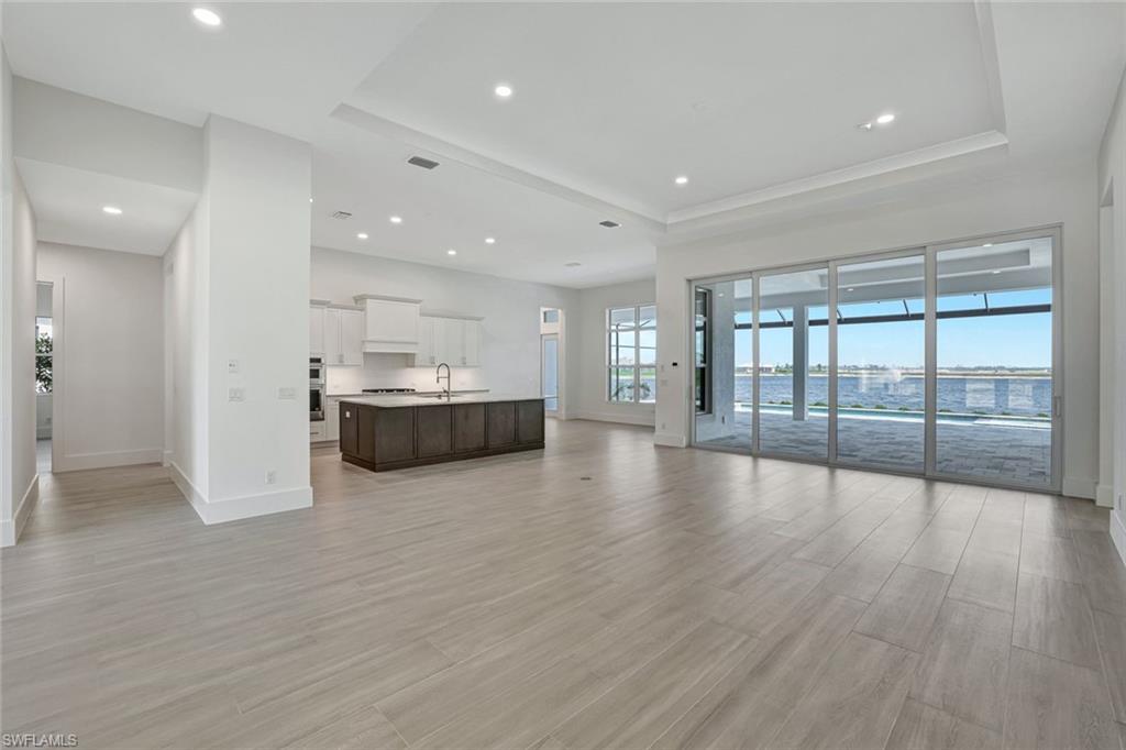 9506 Caymas Way Naples, FL 34114 - Photo 11 of 50 a view of empty room with wooden floor