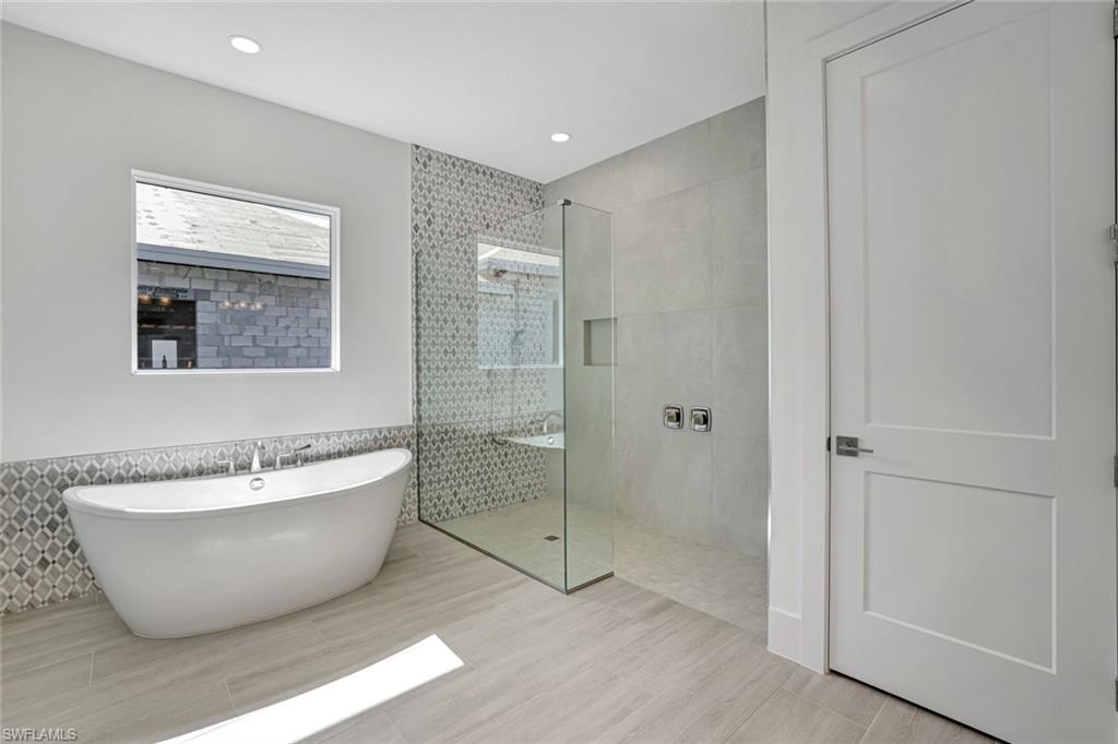9506 Caymas Way Naples, FL 34114 - Photo 24 of 50 a spacious bathroom with a bathtub and shower