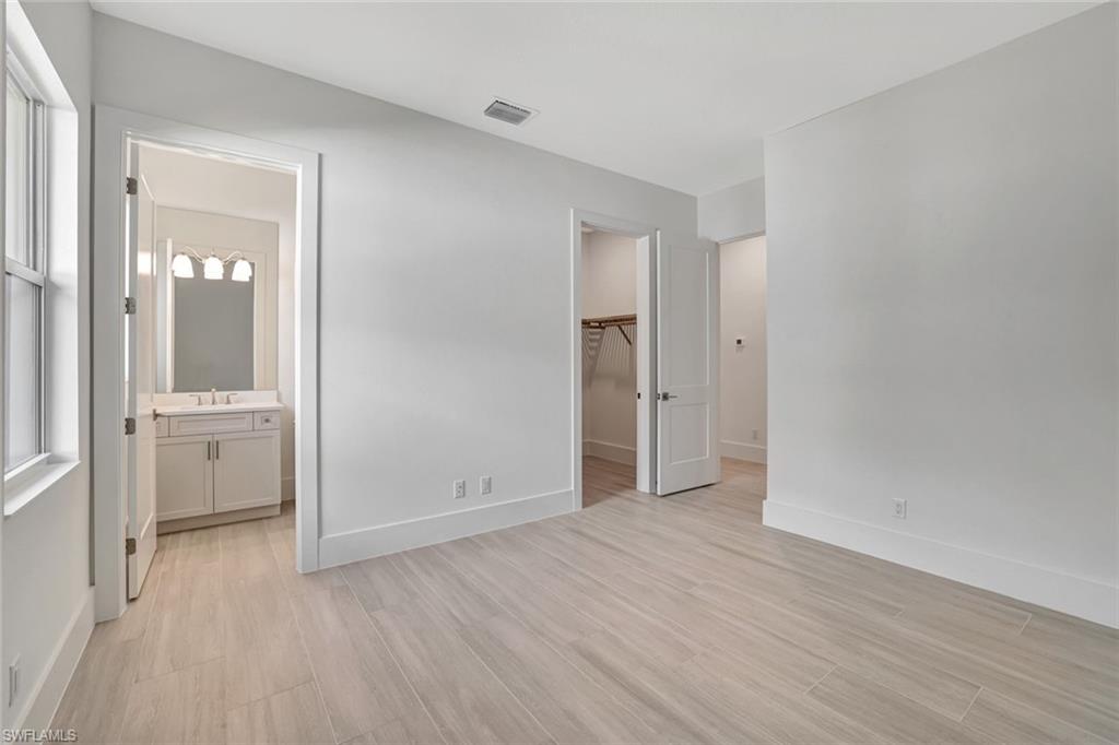9506 Caymas Way Naples, FL 34114 - Photo 25 of 50 wooden floor in an empty room