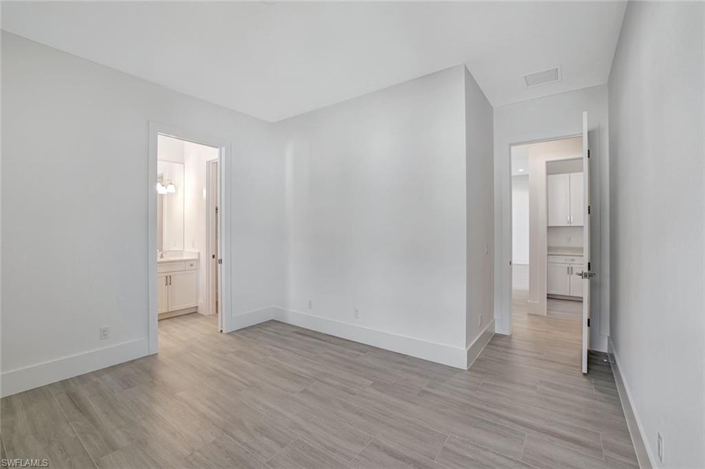 9506 Caymas Way Naples, FL 34114 - Photo 26 of 50 a view of wooden floor and windows in a room