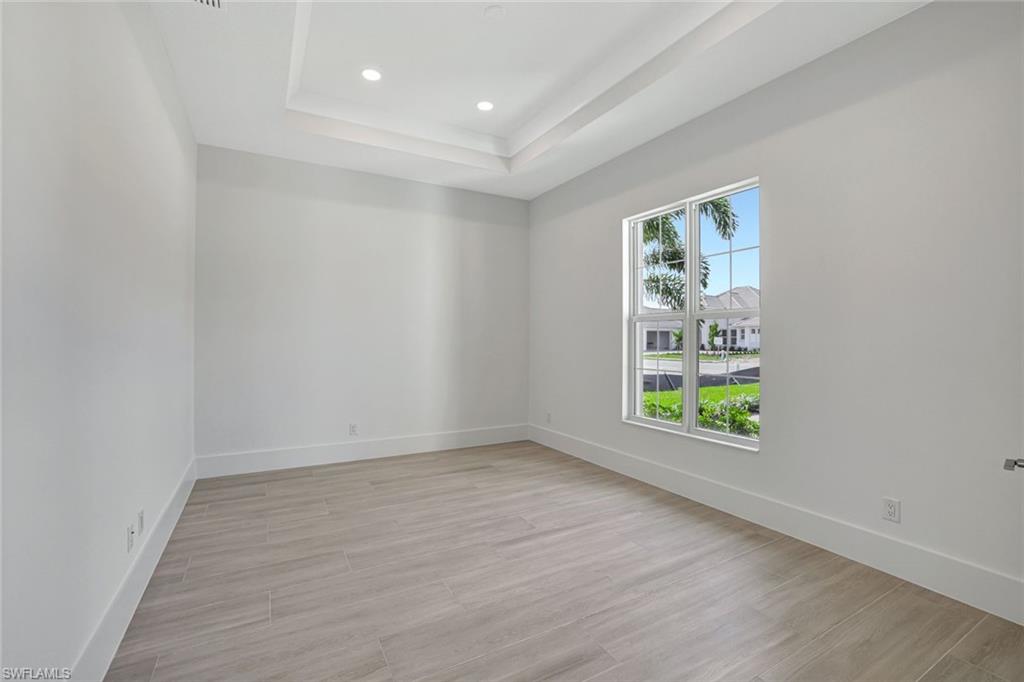 9506 Caymas Way Naples, FL 34114 - Photo 28 of 50 an empty room with windows