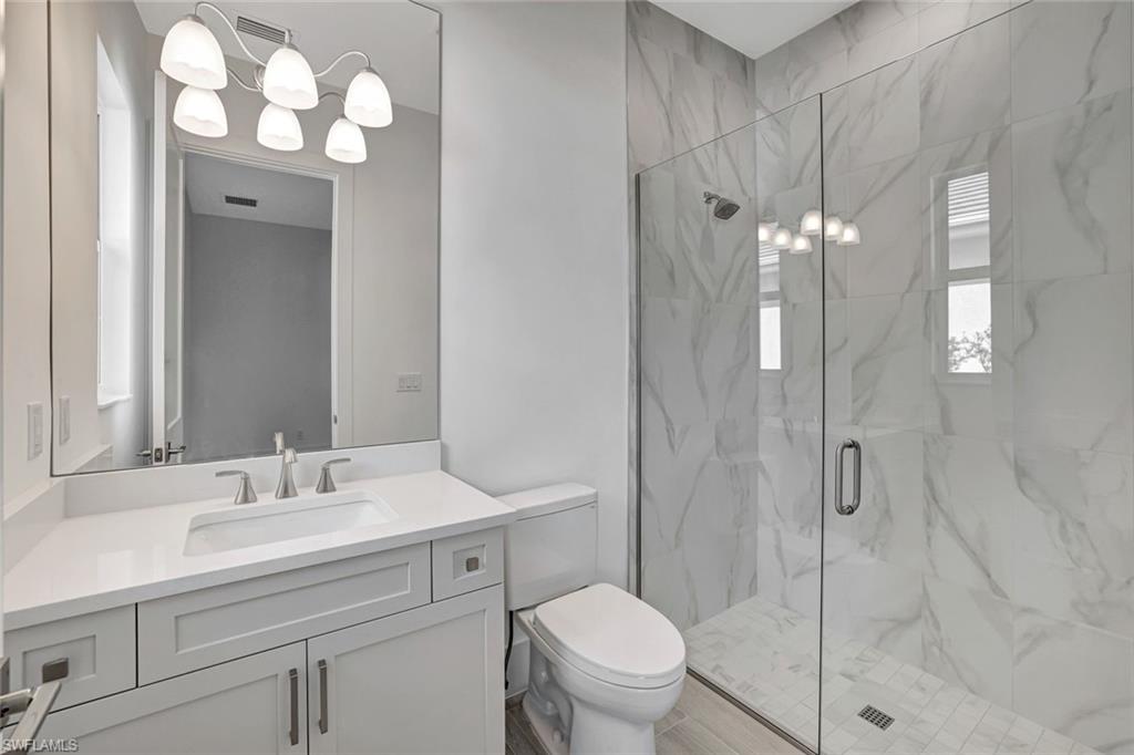 9506 Caymas Way Naples, FL 34114 - Photo 30 of 50 a bathroom with a sink toilet and shower