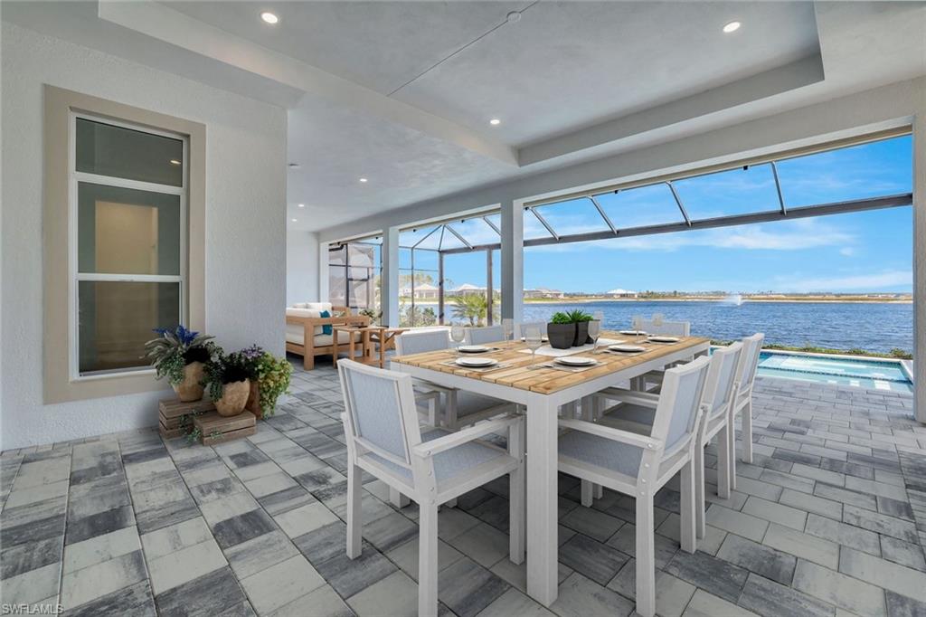 9506 Caymas Way Naples, FL 34114 - Photo 39 of 50 a kitchen with a table and chairs in it