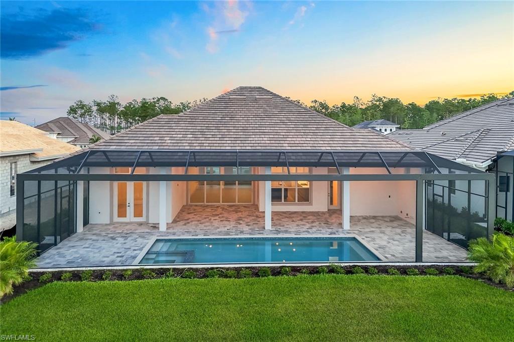 9506 Caymas Way Naples, FL 34114 - Photo 40 of 50 a front view of a house with a yard