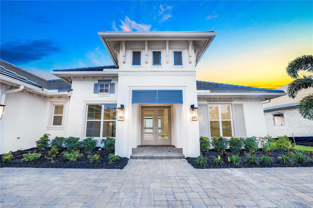 9506 Caymas Way Naples, FL 34114 - Photo 47 of 50 a front view of a house with garden