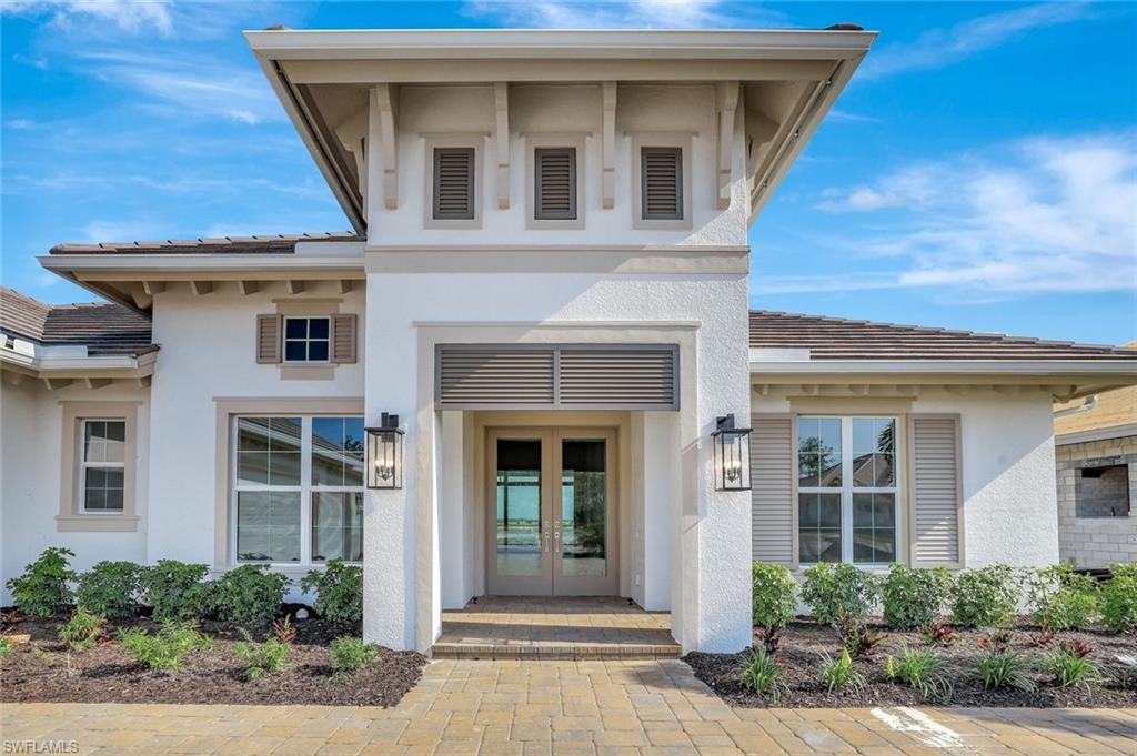 9506 Caymas Way Naples, FL 34114 - Photo 48 of 50 a front view of a house with a yard