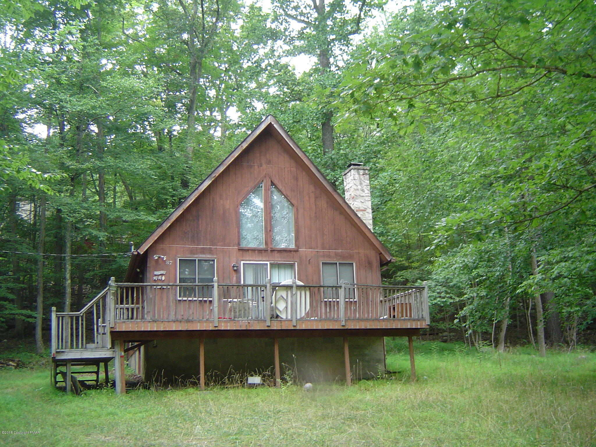 3124 Cherry Ridge Road Bushkill, PA 18324 - Photo 1 of 2 a front view of a house with a garden