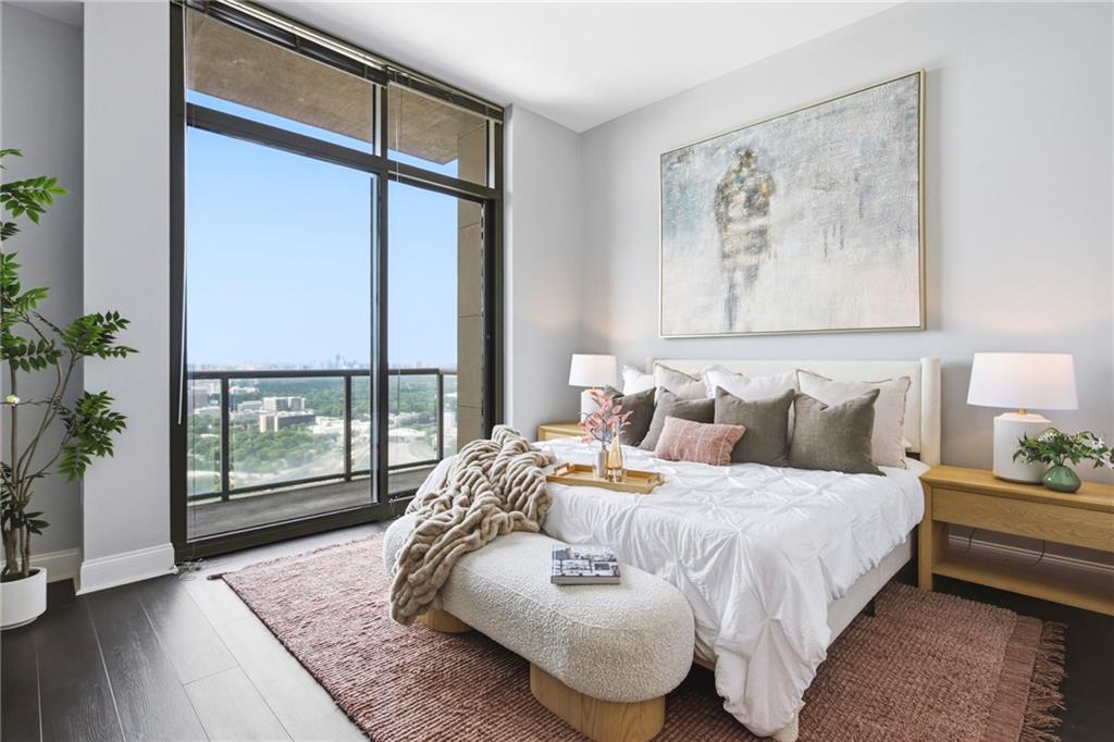 270 17th Street Northwest, Unit 4306 Atlanta, GA 30363 - Photo 22 of 37 a bedroom with bed and a large window with garden view