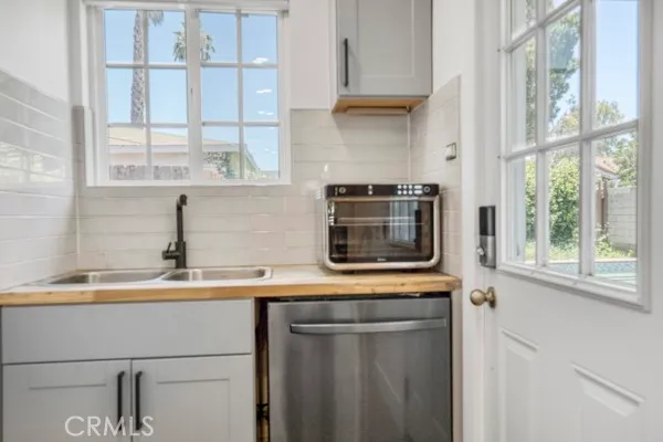 a kitchen with stainless steel appliances a sink a stove and a microwave