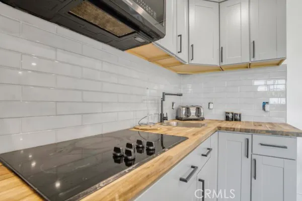 a kitchen with a sink and cabinets