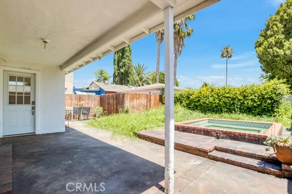 a view of a house with pool and a yard