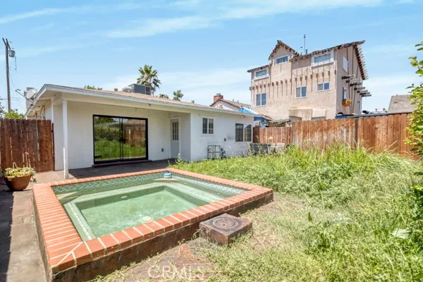 a backyard of a house with table and chairs
