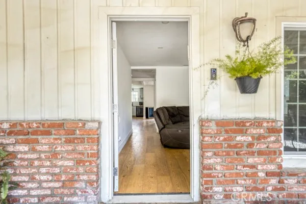 a view of living room filled with furniture and a potted plant