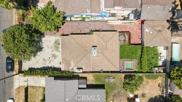 an aerial view of a city with lots of residential buildings and mountain view in back