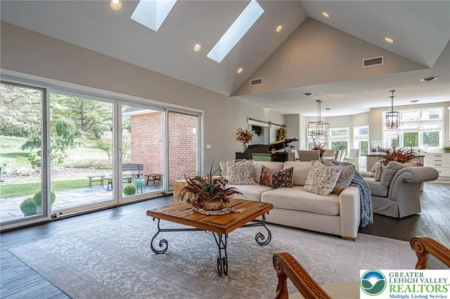 a living room with furniture a flat screen tv and a fireplace