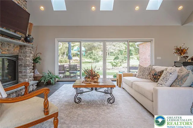 a living room with furniture a rug and a large window