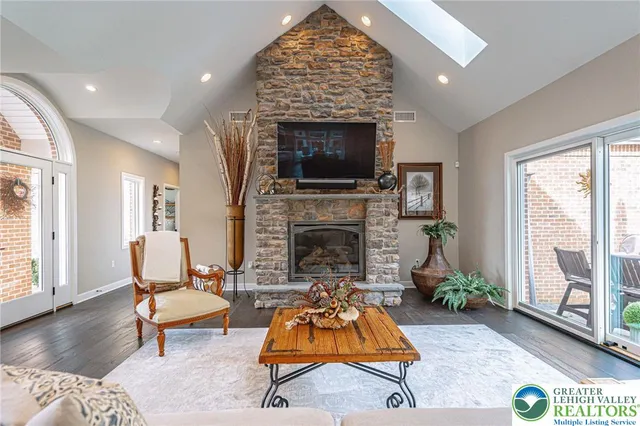 a living room with furniture a fireplace and a flat screen tv