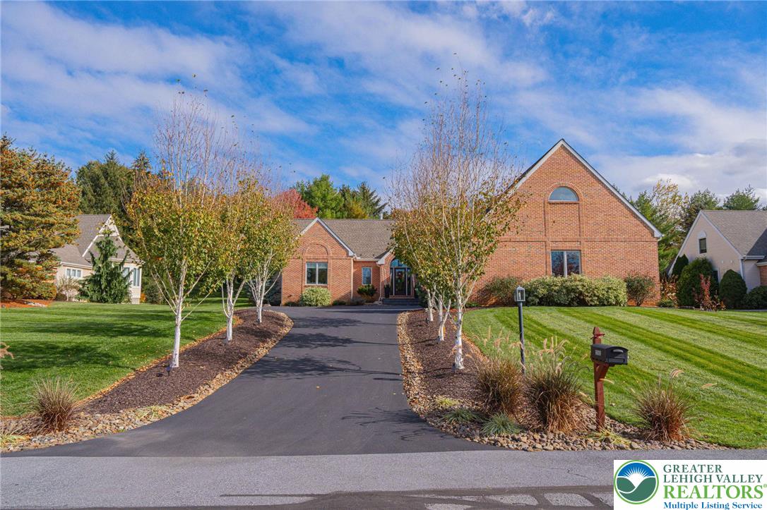 2560 Gracie Lone Lower Macungie Township, PA 18062 - Photo 2 of 68 a front view of a house with a yard and garage