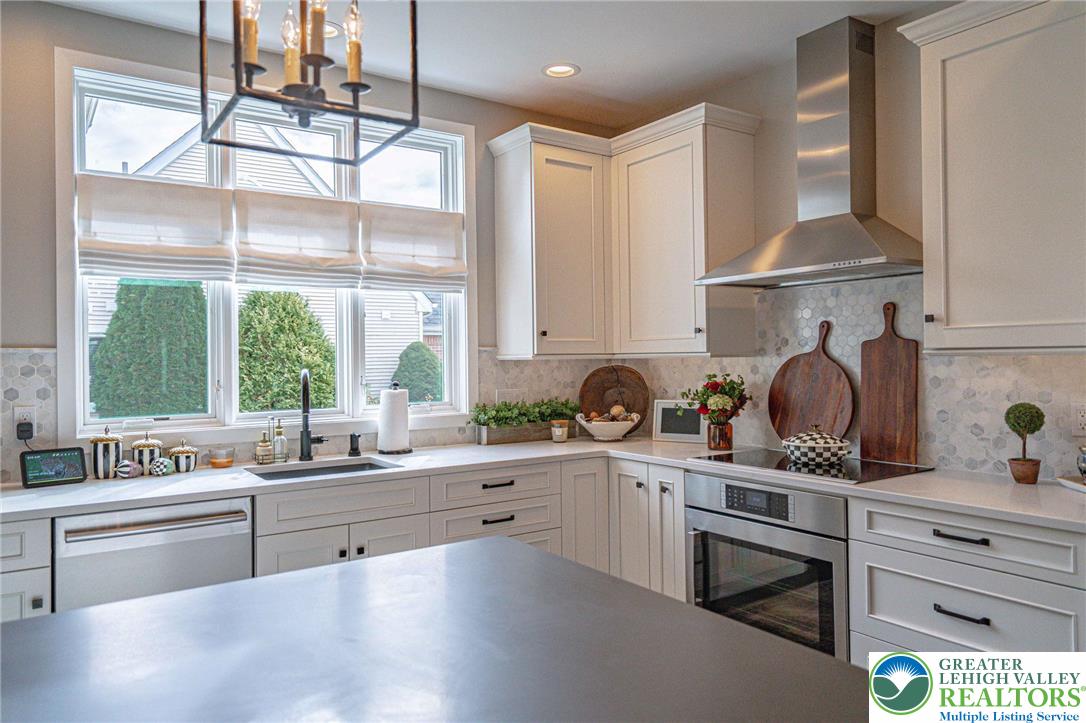 2560 Gracie Lone Lower Macungie Township, PA 18062 - Photo 21 of 68 a kitchen with stainless steel appliances a sink a stove and cabinets