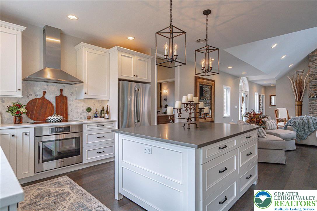 2560 Gracie Lone Lower Macungie Township, PA 18062 - Photo 24 of 68 a kitchen with stainless steel appliances kitchen island granite countertop a sink and a refrigerator
