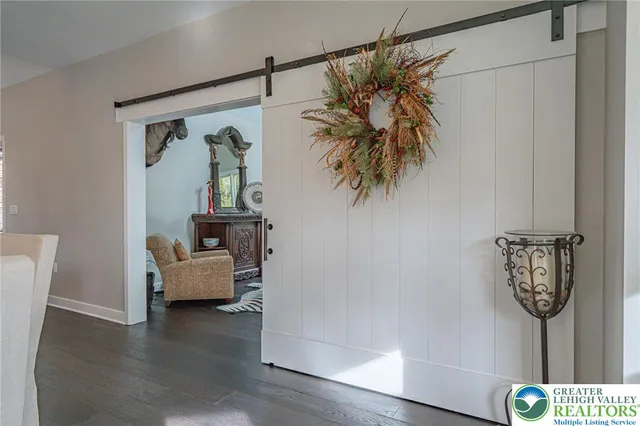 a living room with furniture and a mirror