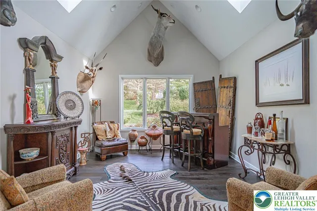 a bedroom with furniture and a flat screen tv