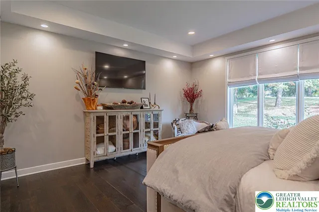 a bathroom with a granite countertop sink a toilet and bathtub