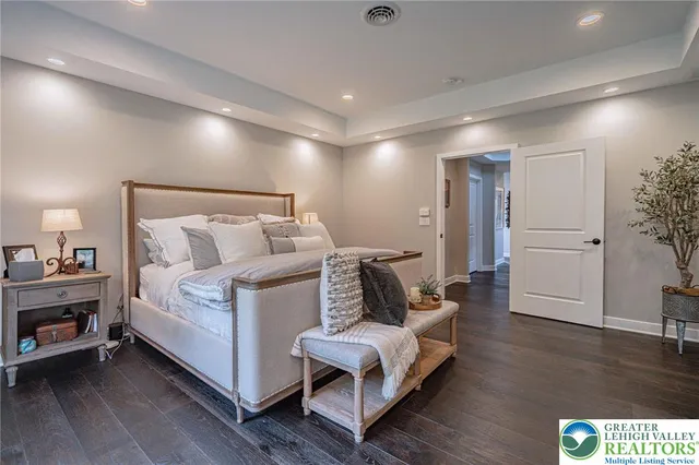 a living room with furniture a wooden floor and a flat screen tv