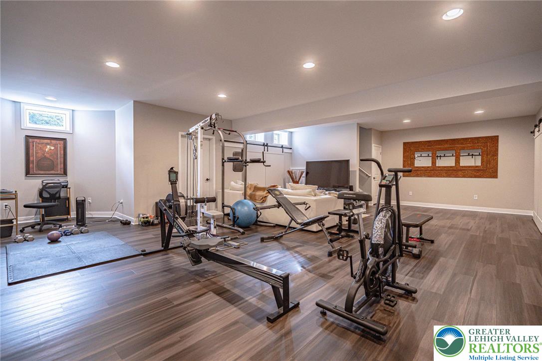 2560 Gracie Lone Lower Macungie Township, PA 18062 - Photo 58 of 68 a living room with furniture a wooden floor and a flat screen tv