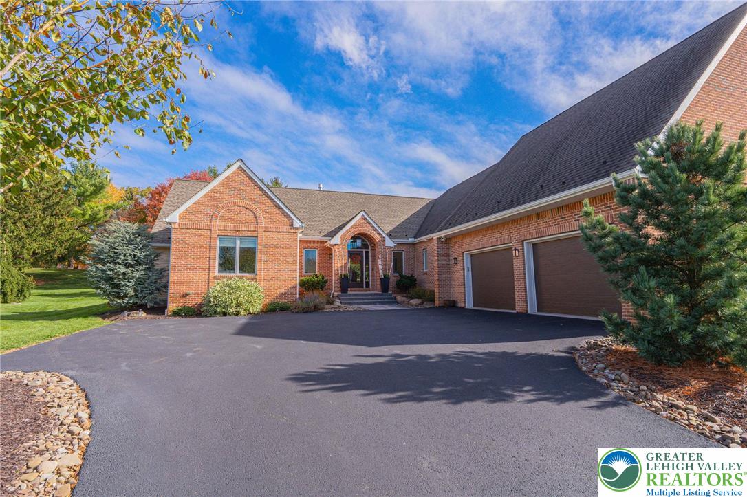 2560 Gracie Lone Lower Macungie Township, PA 18062 - Photo 7 of 68 a front view of a house with a yard and garage