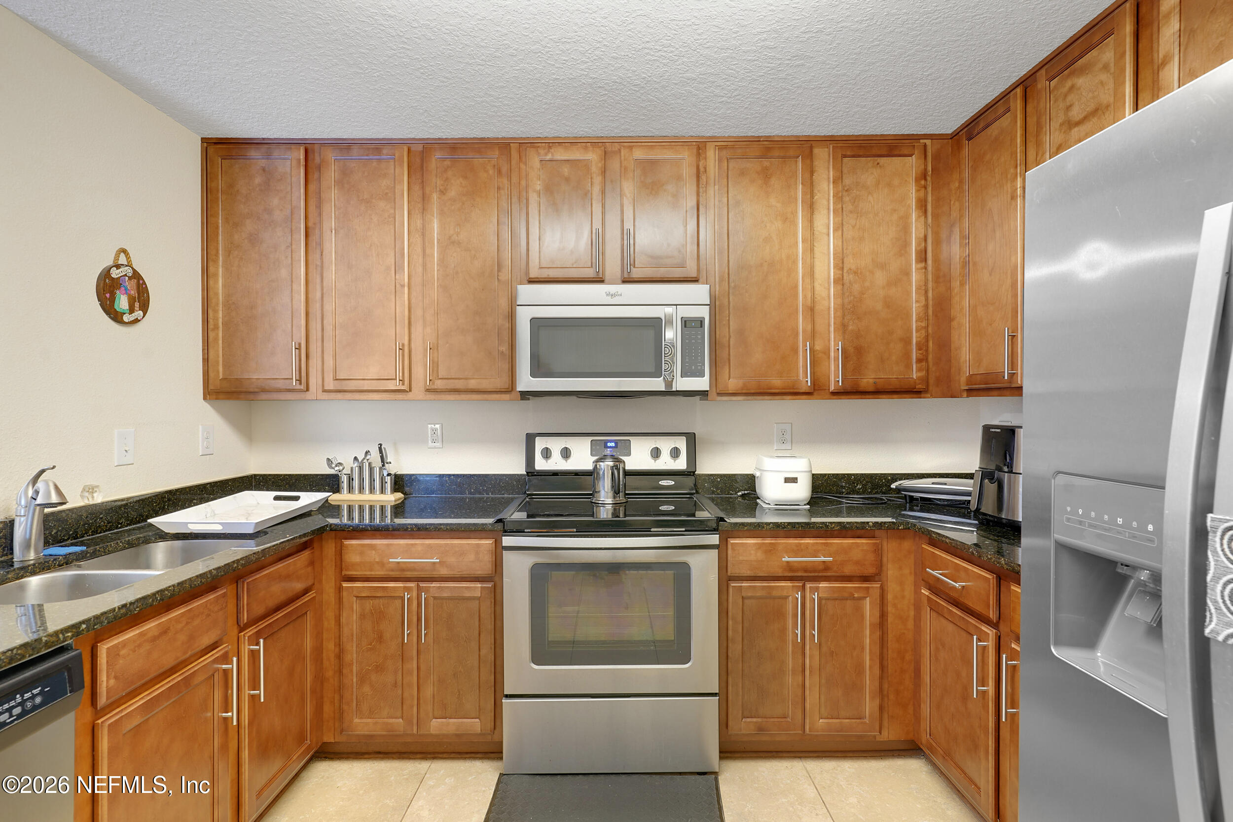 1424 Golden Lake Loop St. Augustine, FL 32084 - Photo 19 of 40 a kitchen with stainless steel appliances granite countertop a stove a sink and a microwave