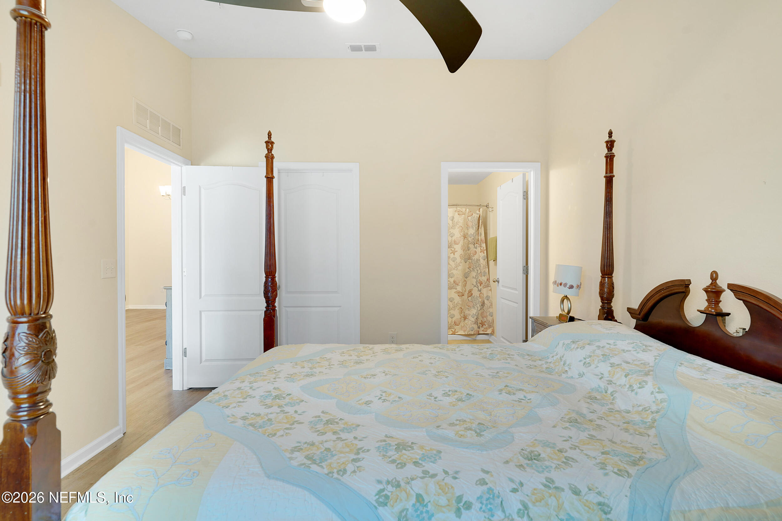 1424 Golden Lake Loop St. Augustine, FL 32084 - Photo 23 of 40 a bedroom with a bed and a chandelier