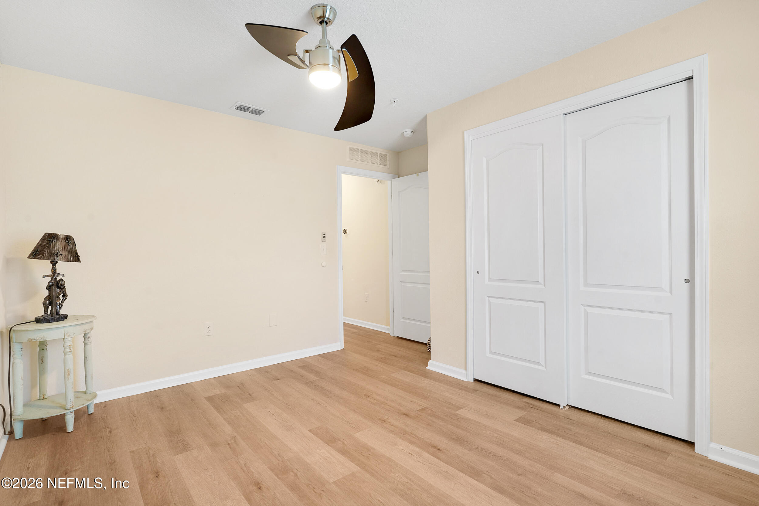 1424 Golden Lake Loop St. Augustine, FL 32084 - Photo 31 of 40 an empty room with wooden floor and windows
