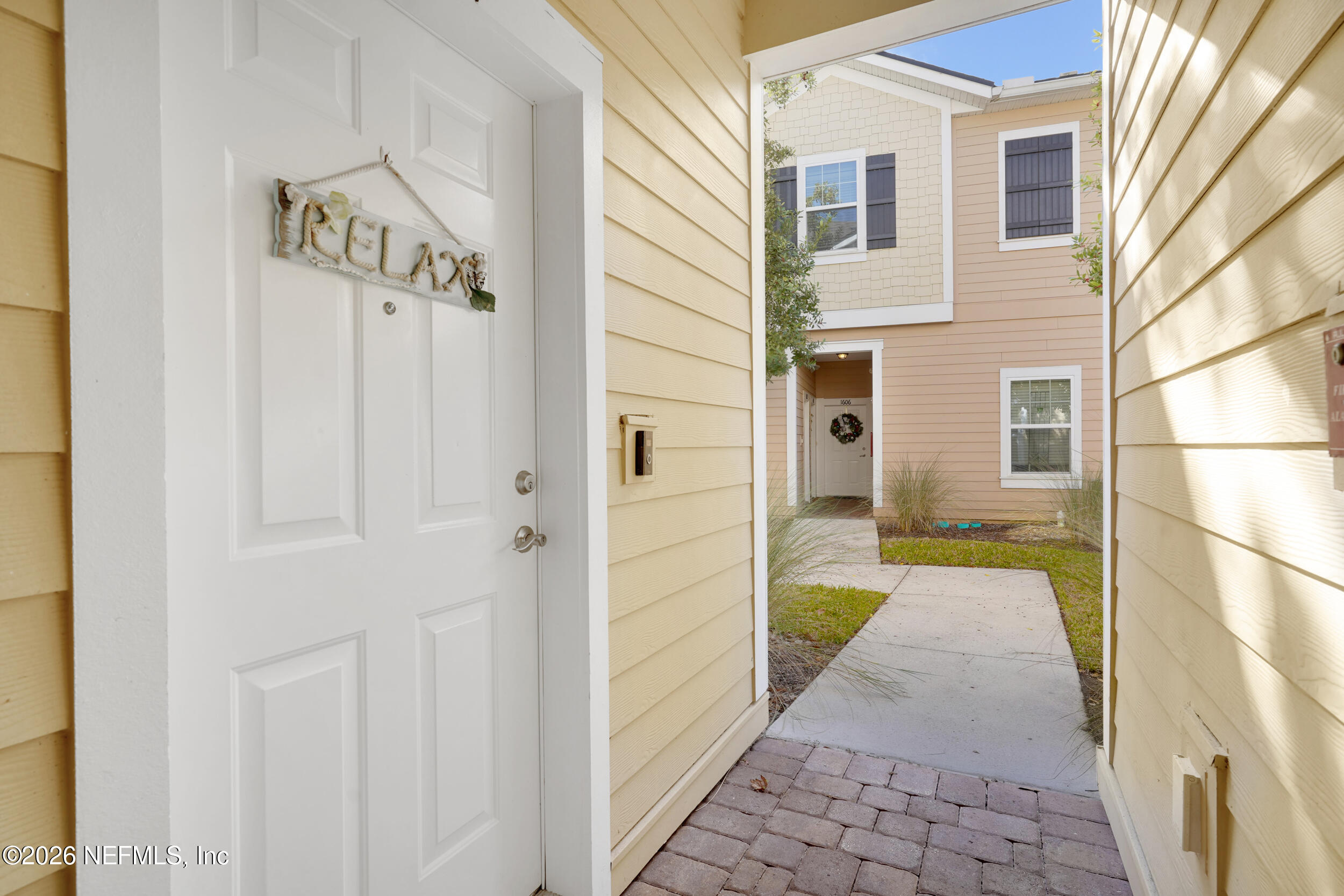 1424 Golden Lake Loop St. Augustine, FL 32084 - Photo 35 of 40 a view of a hallway with a door and windows