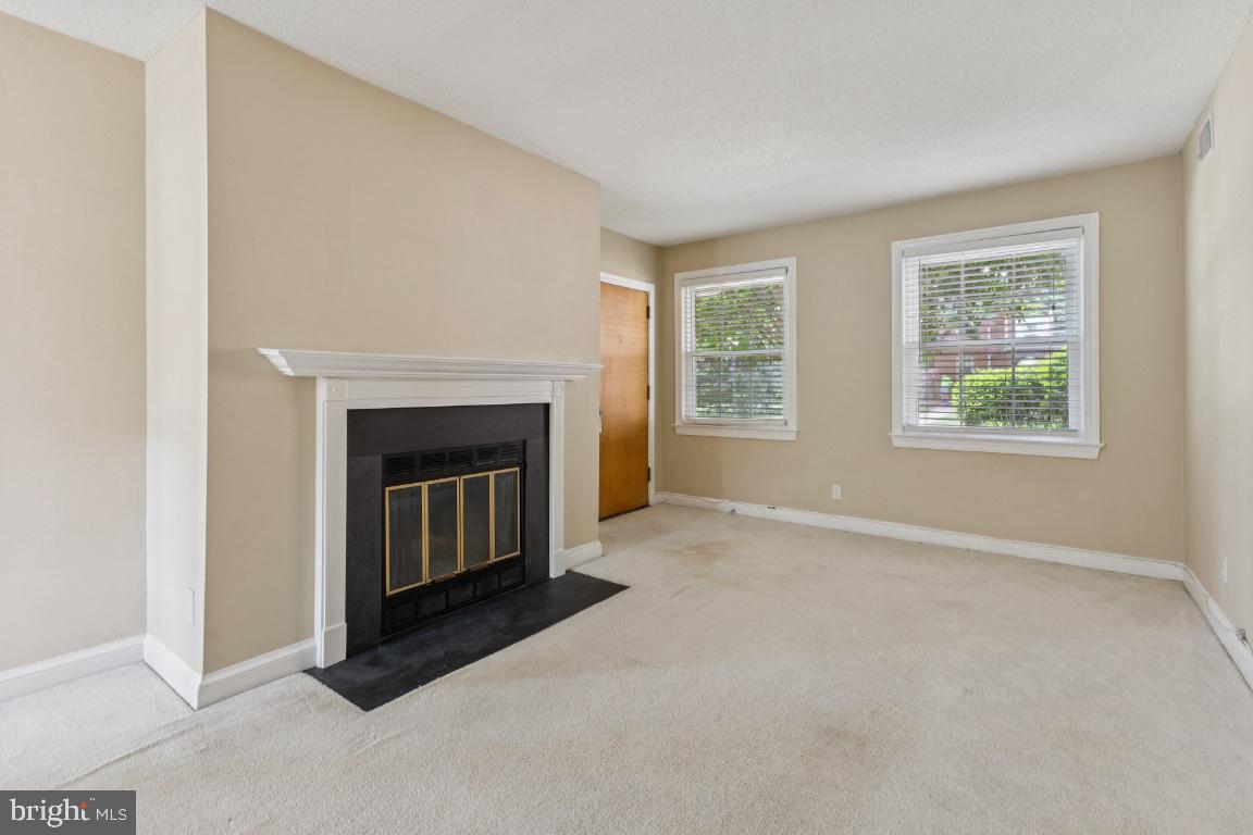 2803 Arlington Boulevard, Unit 101 Arlington, VA 22201 - Photo 2 of 12 an empty room with windows and fireplace