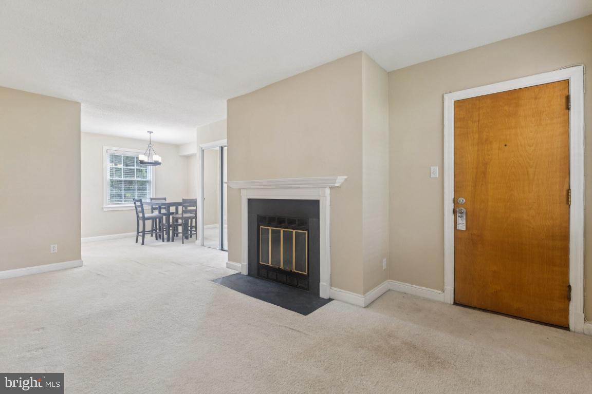 2803 Arlington Boulevard, Unit 101 Arlington, VA 22201 - Photo 3 of 12 a view of an empty room with a fireplace