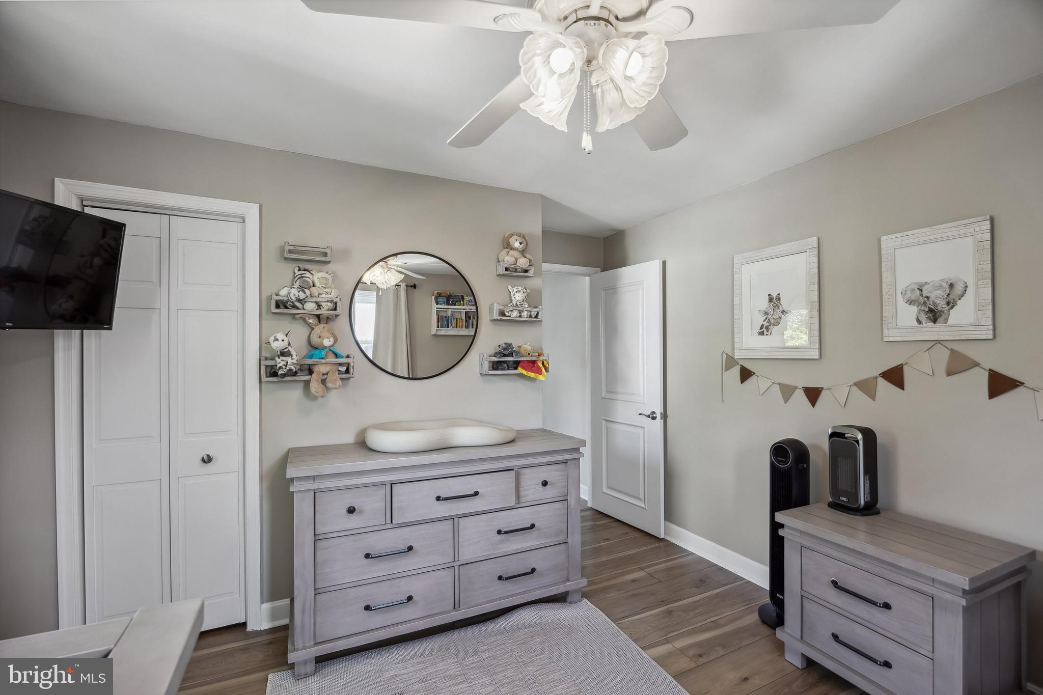 805 Delaware Avenue Riverside, NJ 08075 - Photo 17 of 42 a bedroom with a bed a mirror and a flat tv screen on the dresser