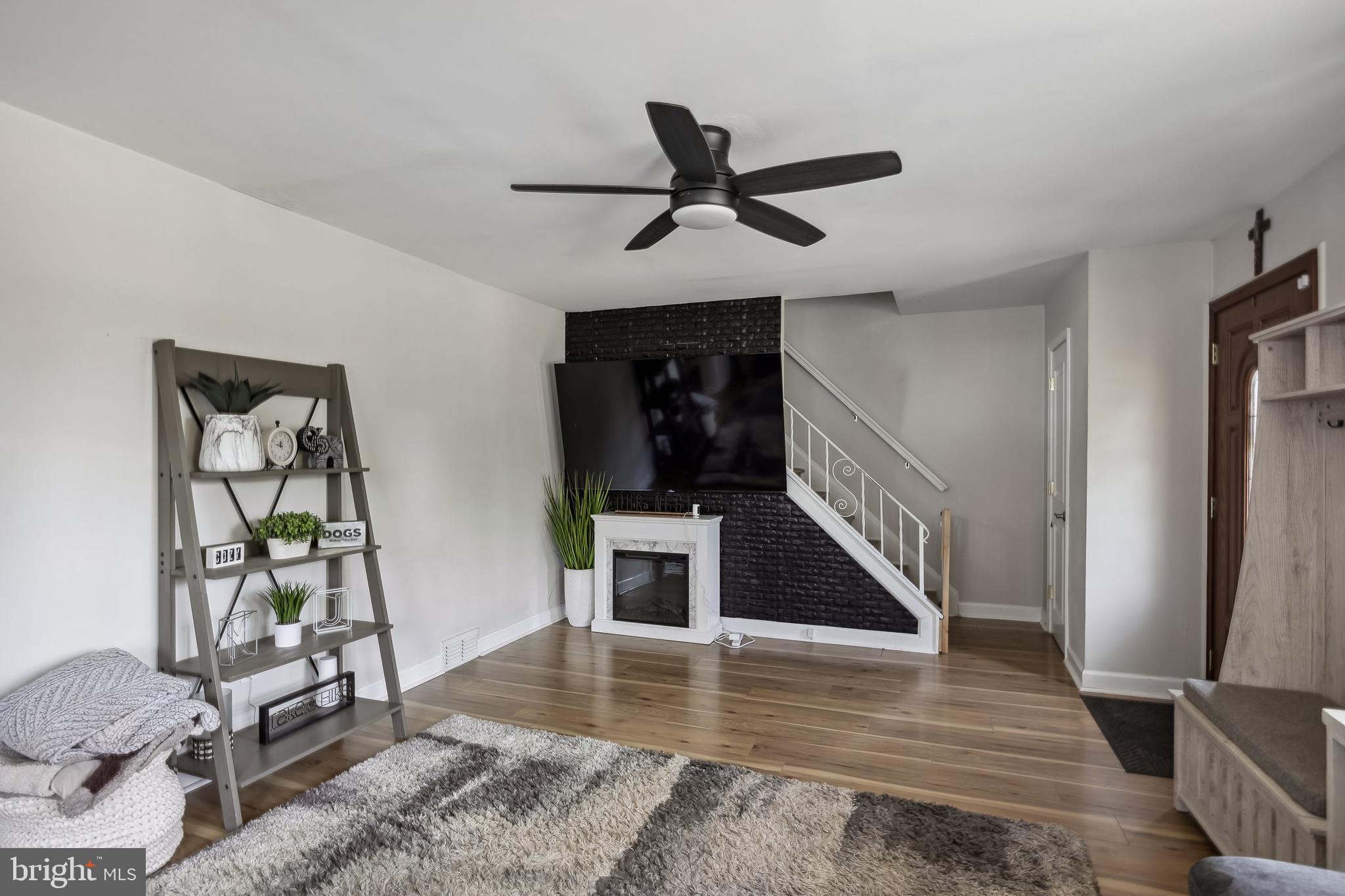 805 Delaware Avenue Riverside, NJ 08075 - Photo 5 of 42 a view of a livingroom with wooden floor and a ceiling fan